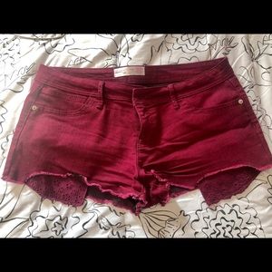Maroon colored jean shorts